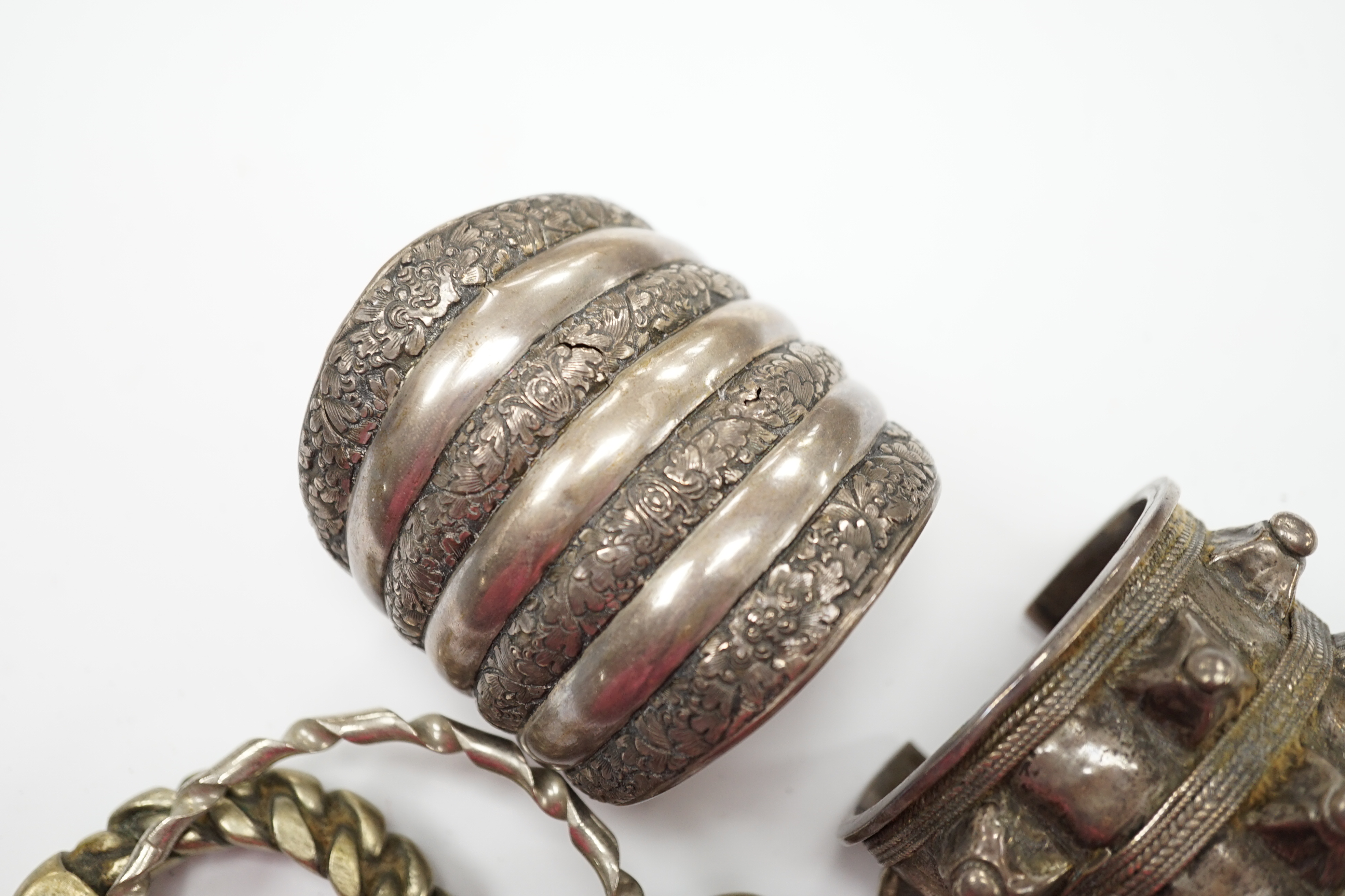 Six assorted Egyptian bracelets, including white metal bangles and two white metal cuff bracelets. Fair condition.
